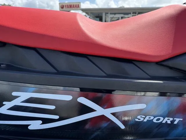 Slide: The Image of 2024 Yamaha WaveRunner EX in red, side view, parked with other jet skis. - 8