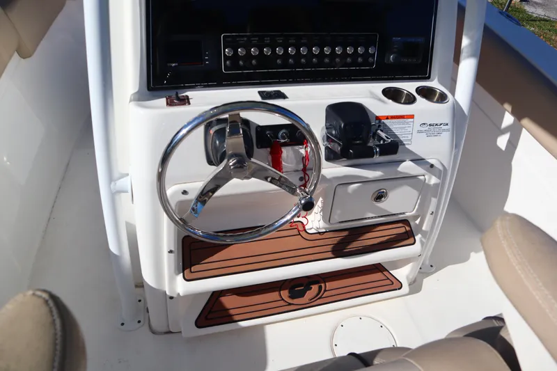Slide: The Image of 2017 Sea Fox 288 Commander helm with steering wheel and control panel. - 13