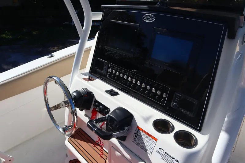 Slide: The Image of 2017 Sea Fox 288 Commander boat dashboard with steering wheel and control panel. - 17