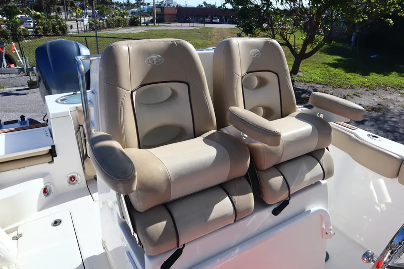 Slide: The Image of 2017 Sea Fox 288 Commander boat seats, beige leather, dual captain's chairs, outdoor setting. - 18
