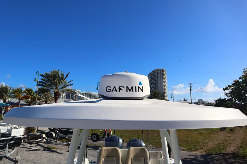 Slide: The Image of 2017 Sea Fox 288 Commander boat with radar, palm trees, and cityscape in the background. - 21