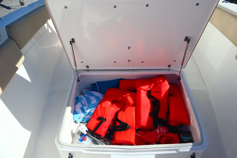 Slide: The Image of Open storage compartment on 2017 Sea Fox 288 Commander with life jackets and supplies. - 22