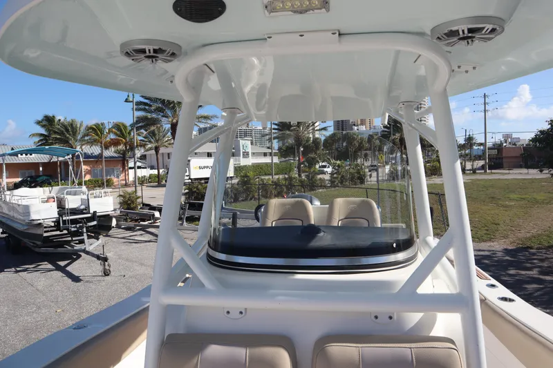 Slide: The Image of 2017 Sea Fox 288 Commander boat with T-top and seating, parked outdoors. - 23