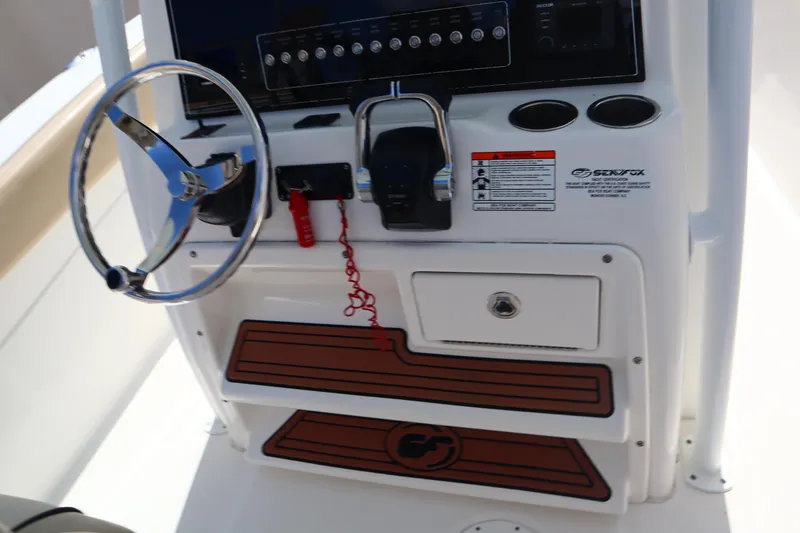 Slide: The Image of 2017 Sea Fox 288 Commander helm with steering wheel and control panel. - 30