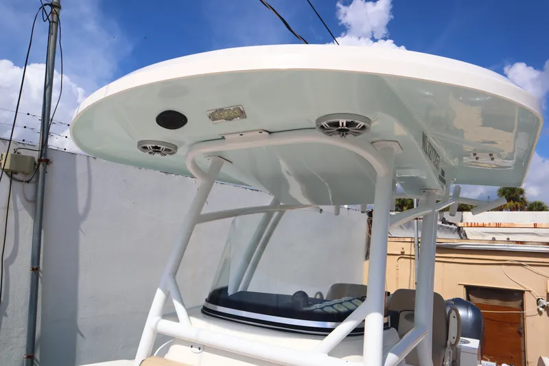 Slide: The Image of 2017 Sea Fox 288 Commander boat with T-top and speakers, docked outdoors. - 37