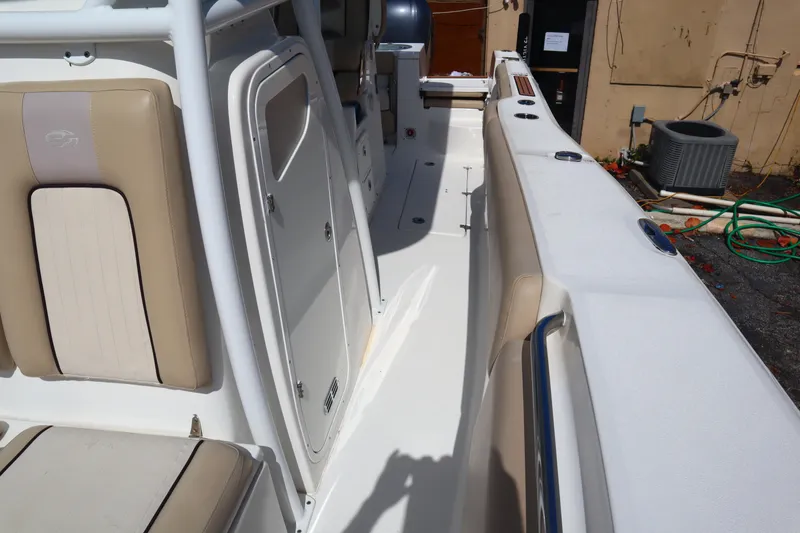 Slide: The Image of 2017 Sea Fox 288 Commander boat interior with beige seating and white deck. - 38