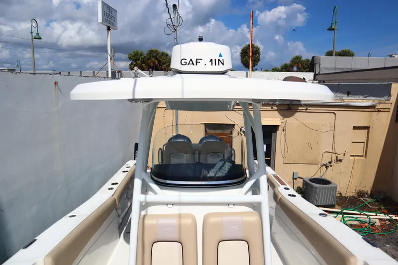 Slide: The Image of 2017 Sea Fox 288 Commander boat docked, featuring a spacious helm and seating area. - 39