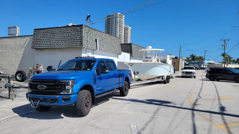 Slide: The Image of Blue truck towing 2017 Sea Fox 288 Commander boat on sunny street. - 4