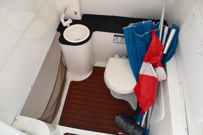 Slide: The Image of 2017 Sea Fox 288 Commander boat bathroom with sink, toilet, and wooden floor. - 42