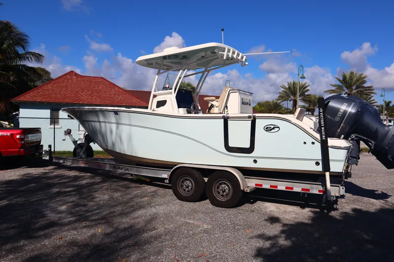 Slide: The Image of 2017 Sea Fox 288 Commander boat on trailer, parked outdoors under clear blue sky. - 5
