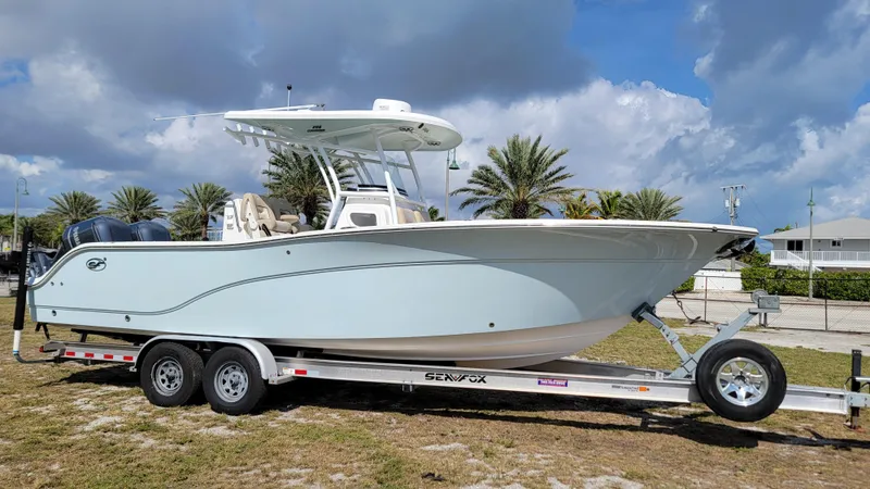 Slide: The Image of 2017 Sea Fox 288 Commander boat on trailer, parked outdoors under cloudy sky. - 6