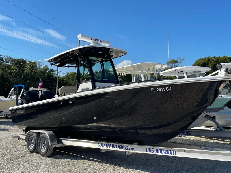 Slide: The Image of 2020 Everglades 273 Center Console boat on trailer, parked outdoors. - 1