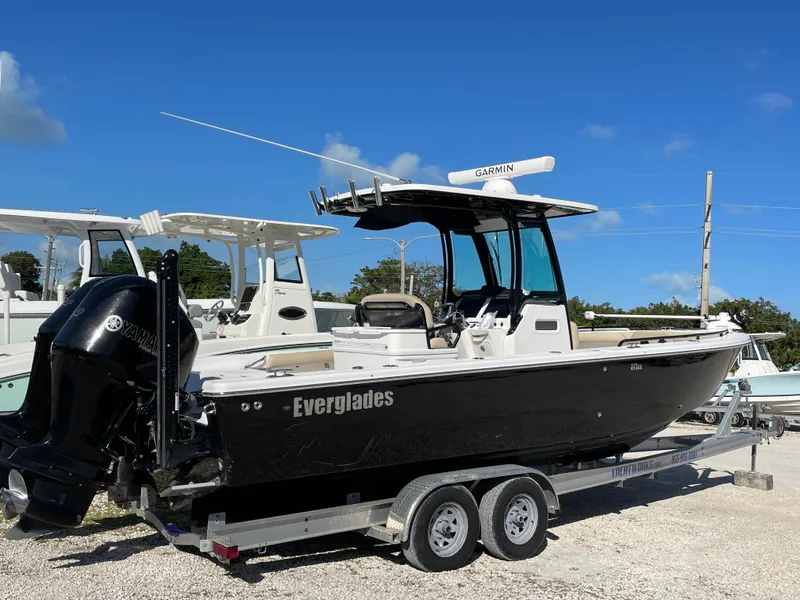 Slide: The Image of 2020 Everglades 273 Center Console boat on trailer under clear blue sky. - 2