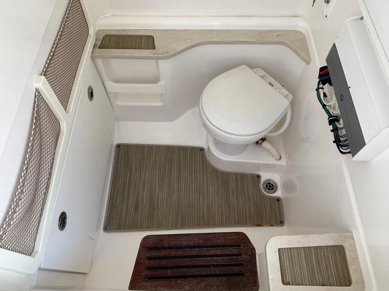 Slide: The Image of 2020 Everglades 273 Center Console boat interior with toilet and storage compartments. - 28