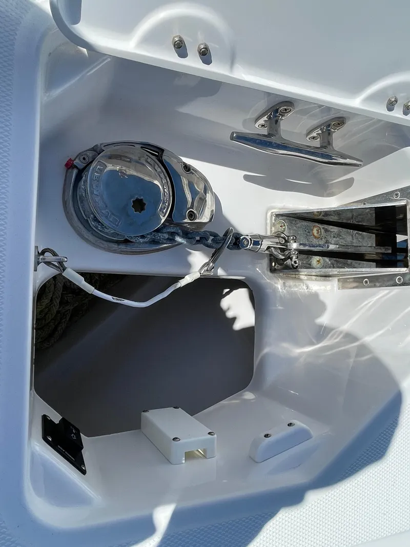Slide: The Image of 2020 Everglades 273 Center Console boat anchor compartment with winch and chain mechanism. - 3