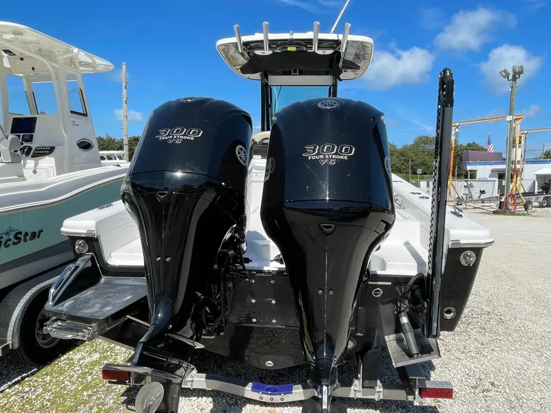 Slide: The Image of 2020 Everglades 273 Center Console boat with twin 300 horsepower engines, docked outdoors. - 36