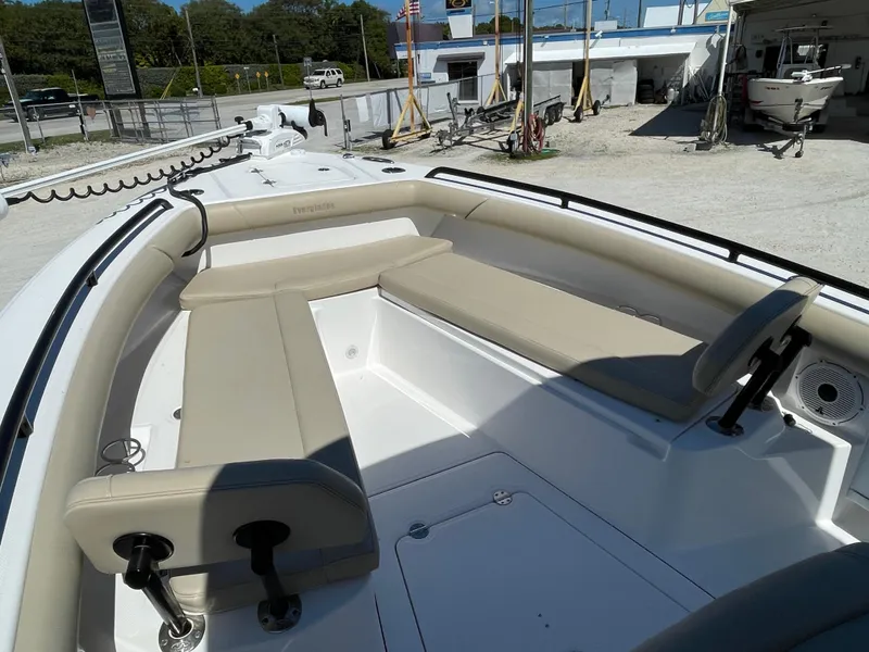Slide: The Image of 2020 Everglades 273 Center Console boat with beige seating in a sunny outdoor setting. - 8