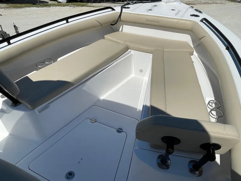 Slide: The Image of 2020 Everglades 273 Center Console boat interior with beige seating and cup holders. - 9