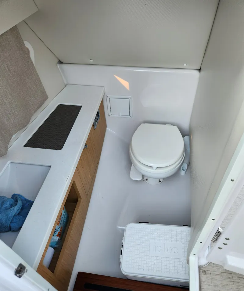 Slide: The Image of 2015 Four Winns Horizon H290 boat bathroom interior with toilet and sink. - 11