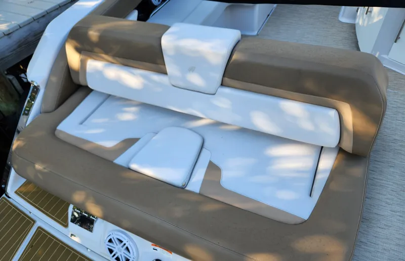 Slide: The Image of 2015 Four Winns Horizon H290 boat seating with beige and white upholstery. - 15