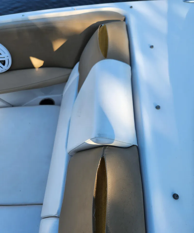 Slide: The Image of Close-up of 2015 Four Winns Horizon H290 boat seating with beige and white upholstery. - 18