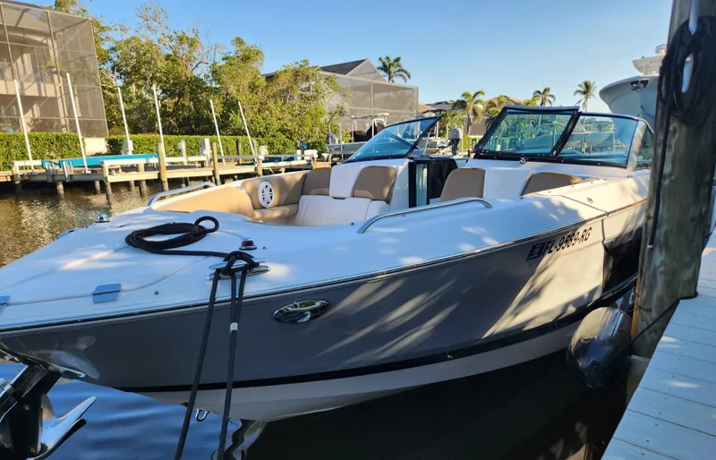 Slide: The Image of 2015 Four Winns Horizon H290 boat docked in a sunny marina setting. - 19