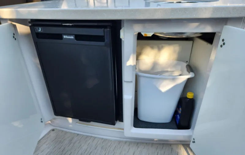Slide: The Image of Compact kitchenette on 2015 Four Winns Horizon H290 boat with fridge and storage. - 7