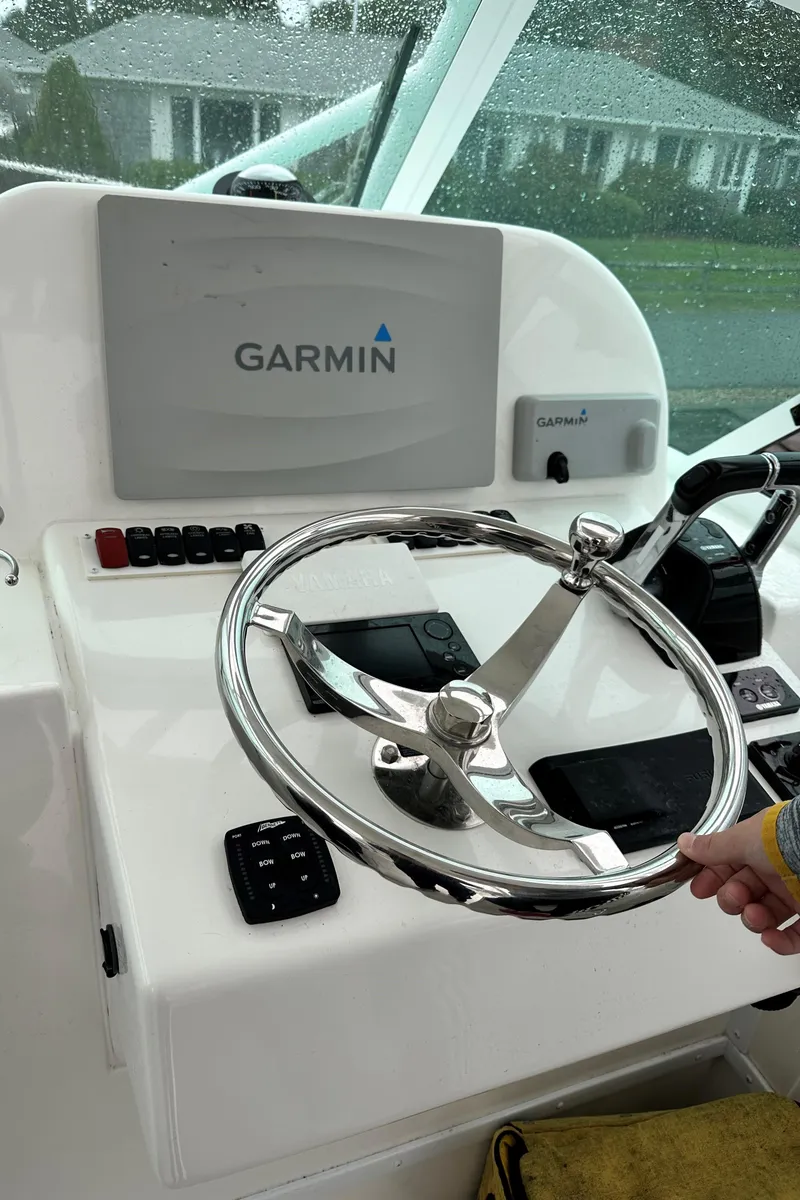 Slide: The Image of 2017 Albemarle 27 Express helm with Garmin navigation system and steering wheel. - 14