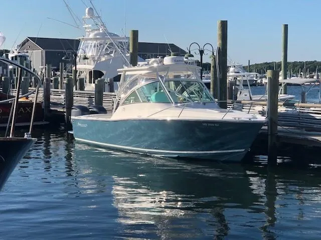 Slide: The Image of 2017 Albemarle 27 Express boat docked at a marina. - 2