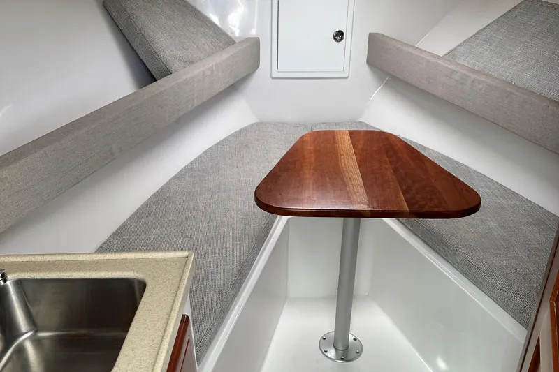 Slide: The Image of 2017 Albemarle 27 Express cabin interior with table and seating. - 21