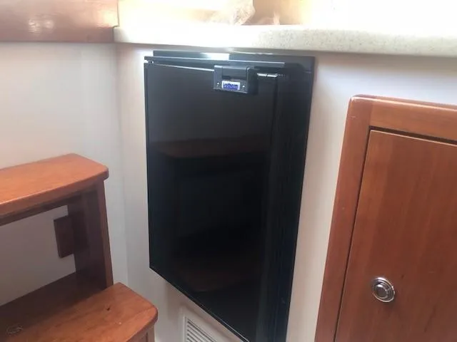 Slide: The Image of Compact refrigerator in 2017 Albemarle 27 Express boat interior. - 28