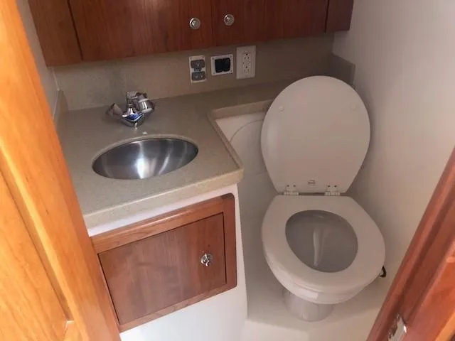 Slide: The Image of 2017 Albemarle 27 Express boat bathroom with sink and toilet. - 29