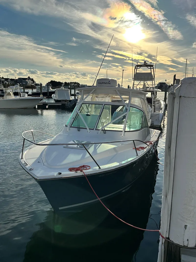 Slide: The Image of 2017 Albemarle 27 Express boat docked at marina under a vibrant sunset sky. - 3
