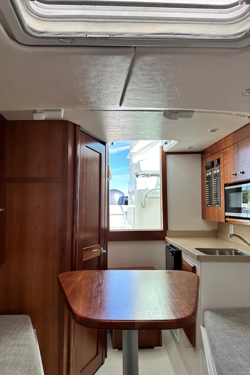 Slide: The Image of Interior of 2017 Albemarle 27 Express boat with wood finishes and modern amenities. - 33