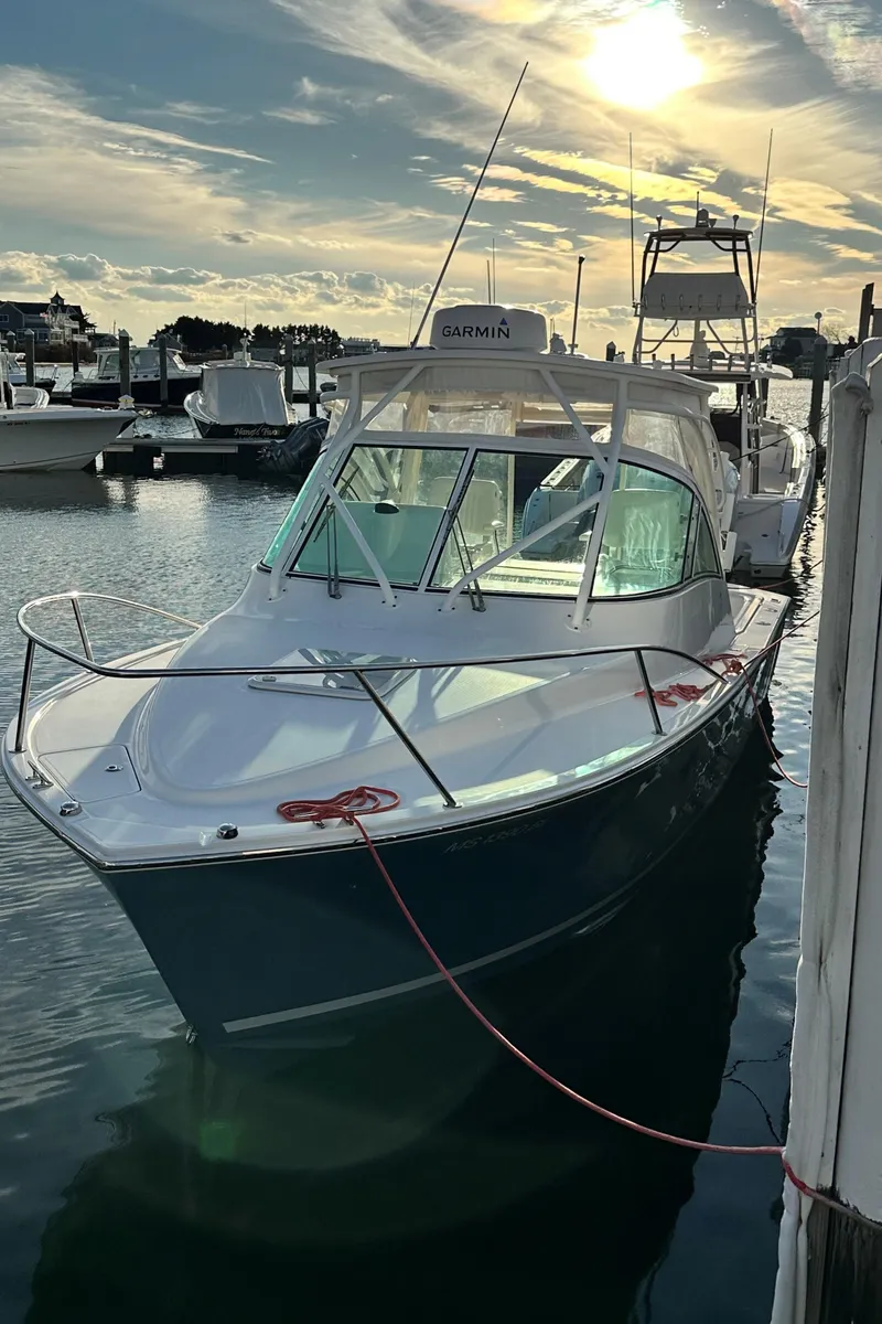 Slide: The Image of 2017 Albemarle 27 Express boat docked at marina under a sunny sky. - 34