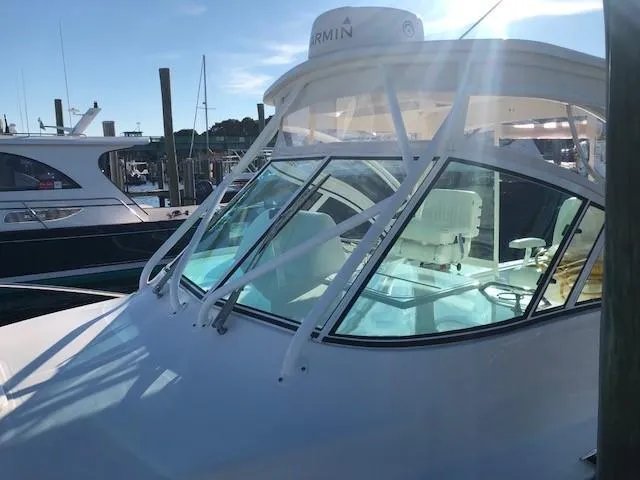 Slide: The Image of 2017 Albemarle 27 Express boat docked in a marina under sunlight. - 6