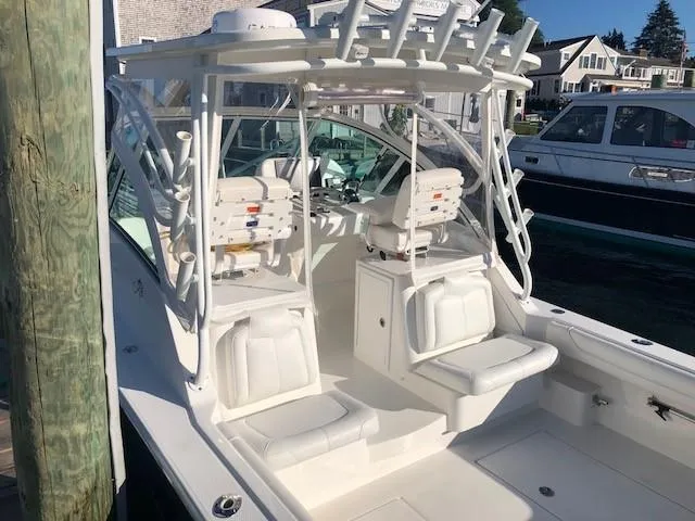 Slide: The Image of 2017 Albemarle 27 Express boat with white seating and fishing rod holders. - 8
