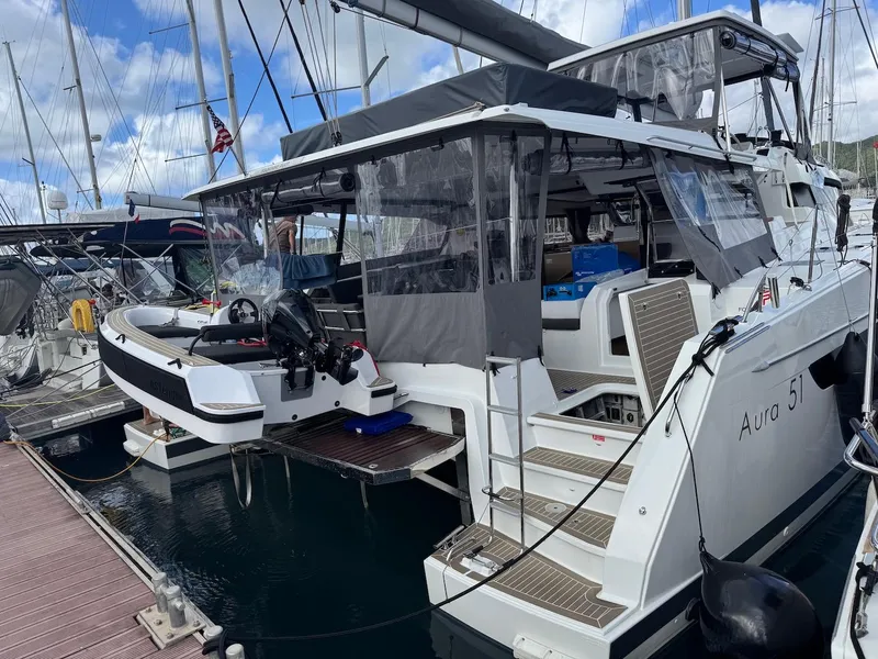 Slide: The Image of 2024 Fountaine Pajot Aura 51 catamaran docked at marina, featuring modern design and spacious deck. - 9