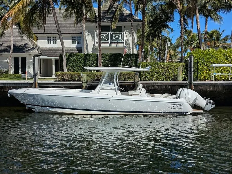 Slide: The Image of Intrepid 327 Center Console boat docked by waterfront home, 2017 model with upgraded motors. - 0