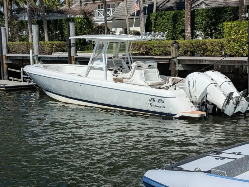 Slide: The Image of Intrepid 327 Center Console 2019 with upgraded motors docked in a marina, 2017 model. - 1