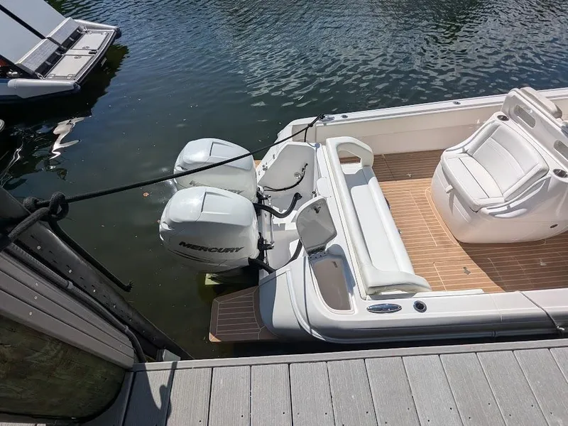 Slide: The Image of Intrepid 327 Center Console boat with upgraded motors docked on calm water. - 11