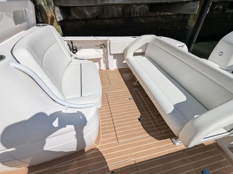 Slide: The Image of Intrepid 327 Center Console 2017 boat interior with white seating and teak flooring. - 16