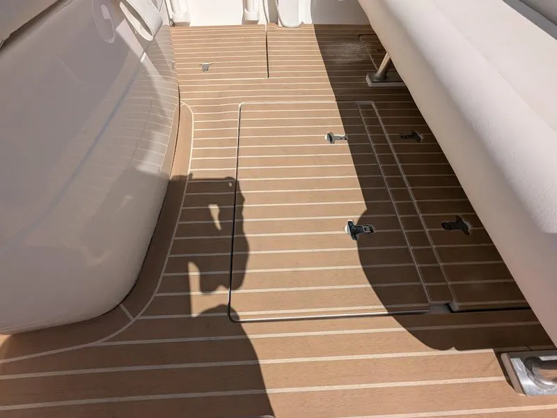 Slide: The Image of Intrepid 327 Center Console 2017 boat deck with upgraded motors, featuring sleek wood finish. - 17