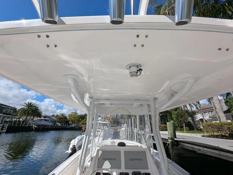 Slide: The Image of Intrepid 327 Center Console 2019 with upgraded motors, docked by a scenic waterfront. - 20