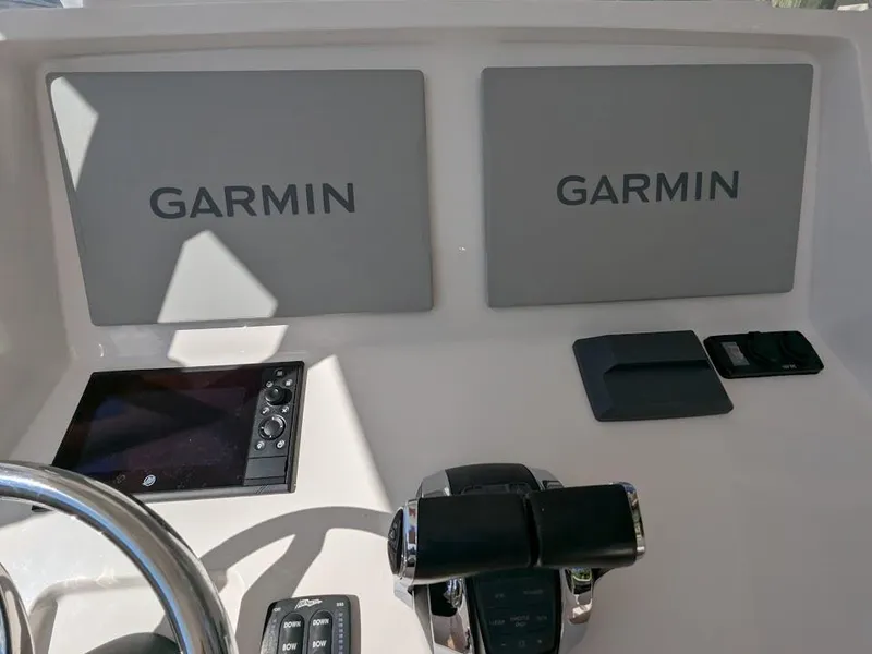 Slide: The Image of Intrepid 327 Center Console 2017 dashboard with Garmin displays and controls. - 23