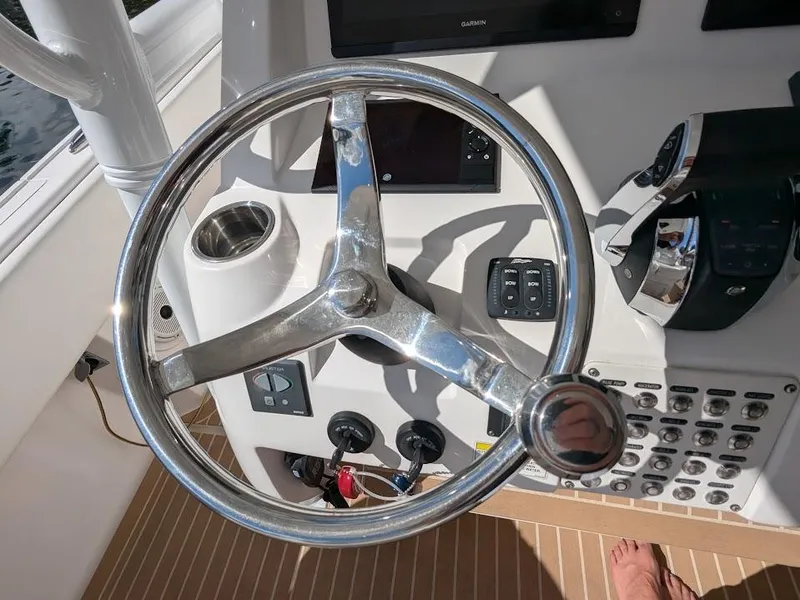 Slide: The Image of Steering wheel of a 2017 Intrepid 327 Center Console boat with upgraded motors. - 25