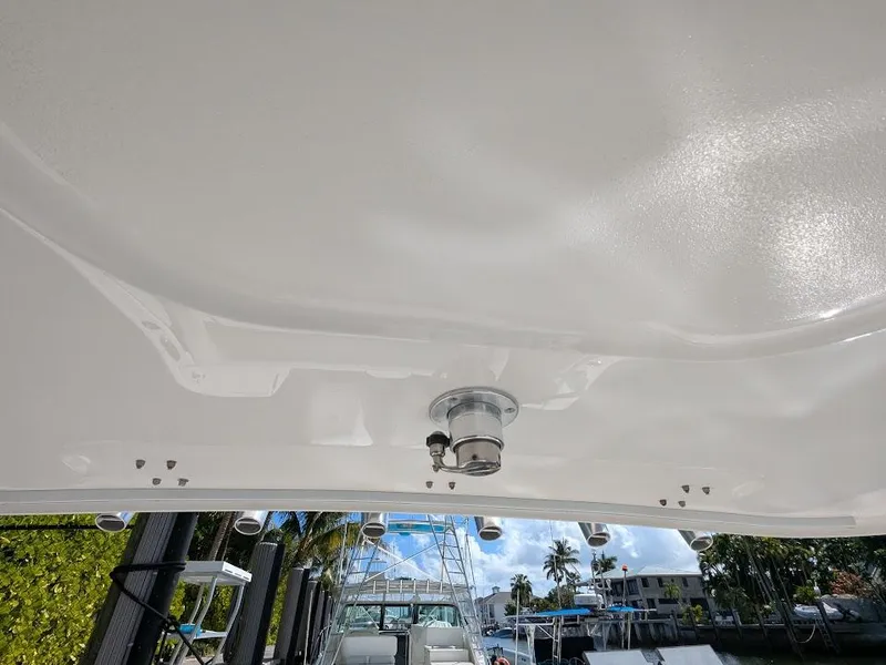 Slide: The Image of Intrepid 327 Center Console 2019, view of the boat's underside, docked in a marina. - 26