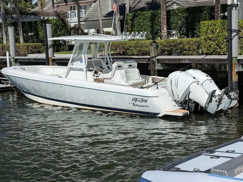 Slide: The Image of Intrepid 327 Center Console boat, 2017 model with upgraded motors, docked in a marina. - 3