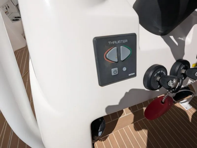 Slide: The Image of Control panel of 2017 Intrepid 327 Center Console with thruster and ignition keys. - 30