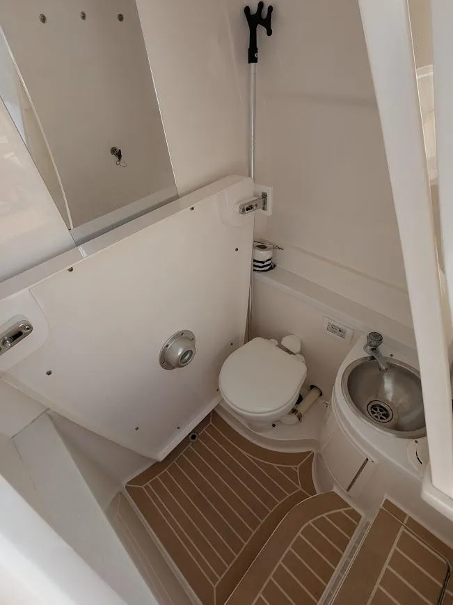 Slide: The Image of Compact bathroom in 2017 Intrepid 327 Center Console boat with upgraded motors. - 36
